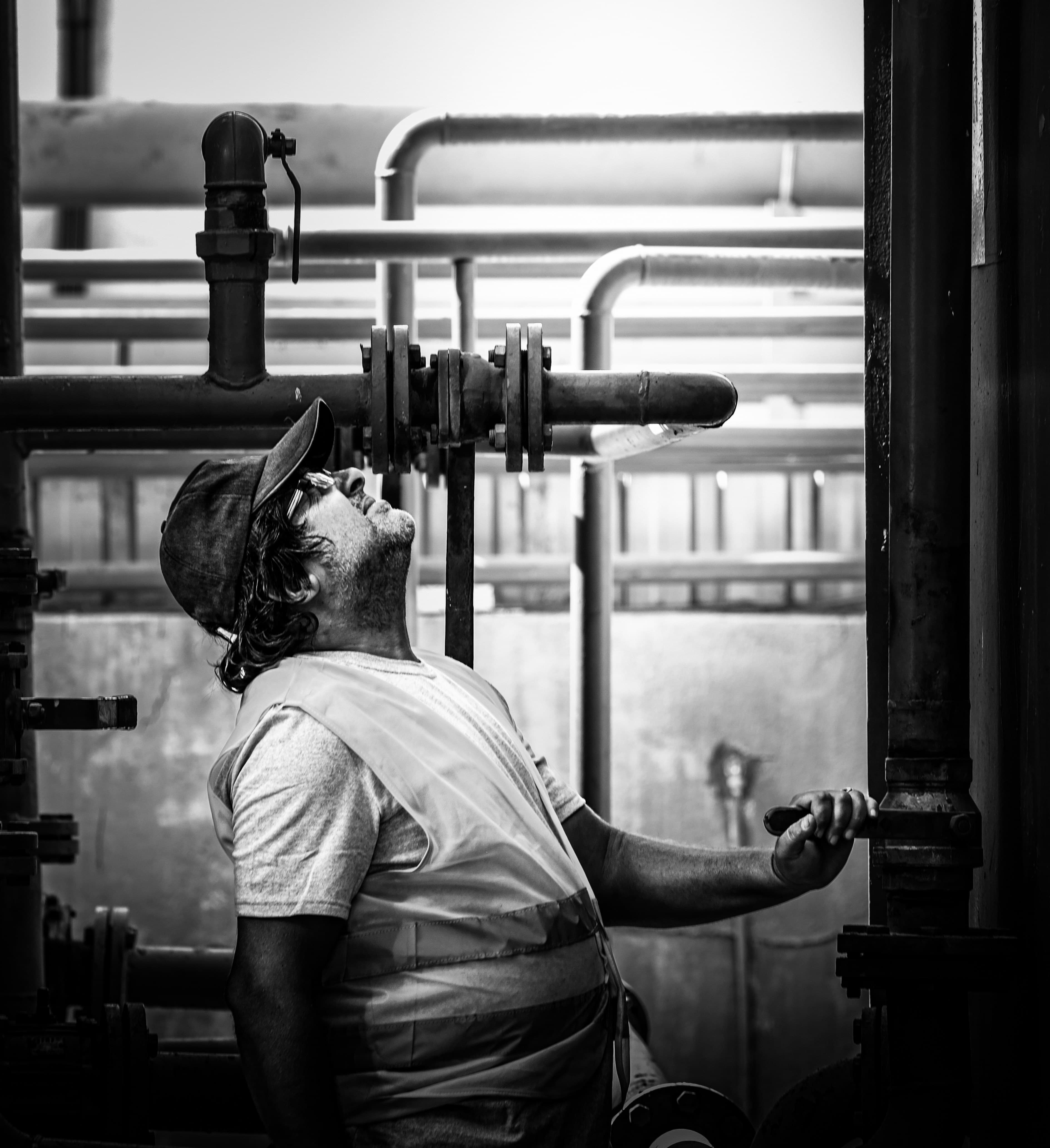 Three Sixty Renovations crew member inspecting industrial pipework on a jobsite